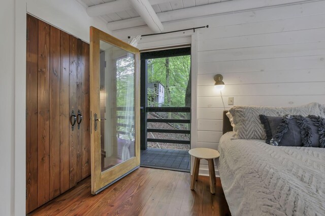 510 Natchez Ln, Sugar Grove, OH 43155 - bedroom featuring wood walls, beamed ceiling, hardwood / wood-style flooring, and access to outside