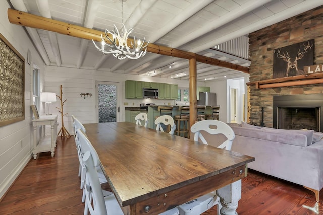 510 Natchez Ln, Sugar Grove, OH 43155 - dining area with dark wood-style floors, a chandelier, beamed ceiling, and a stone fireplace