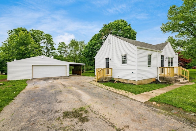 3232 Williams Rd, Columbus, OH 43207 - view of side of property with a garage, an outbuilding, a yard, and roof with shingles