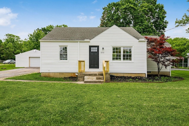 3232 Williams Rd, Columbus, OH 43207 - view of front facade with a garage, roof with shingles, an outbuilding, a front yard, and driveway