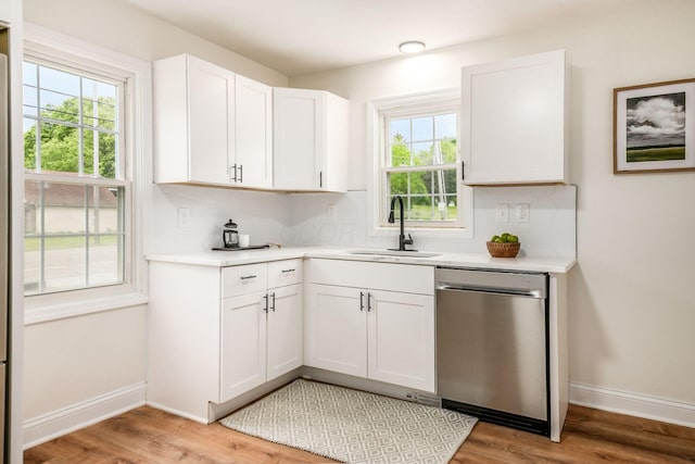 3232 Williams Rd, Columbus, OH 43207 - kitchen with dishwasher, a sink, light countertops, and healthy amount of natural light