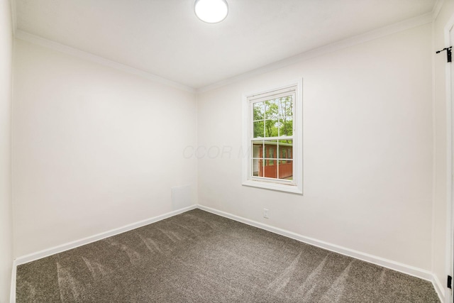 3232 Williams Rd, Columbus, OH 43207 - empty room featuring dark carpet, crown molding, baseboards, and a barn door