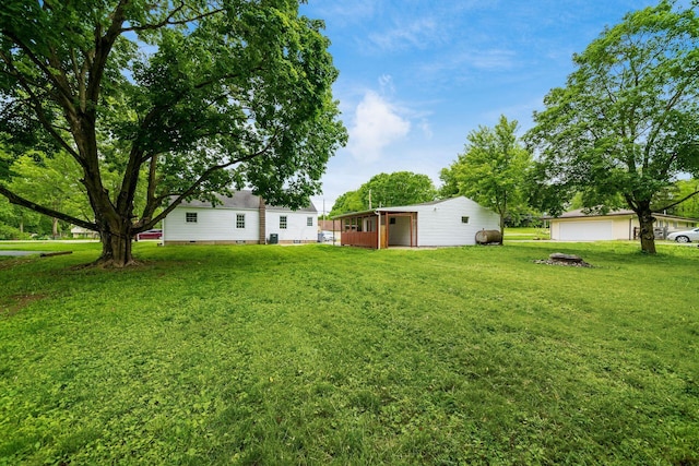3232 Williams Rd, Columbus, OH 43207 - view of grassy yard featuring a detached garage and an outbuilding