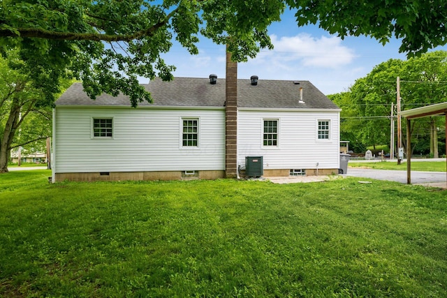 3232 Williams Rd, Columbus, OH 43207 - back of house with central AC unit, a lawn, and a shingled roof