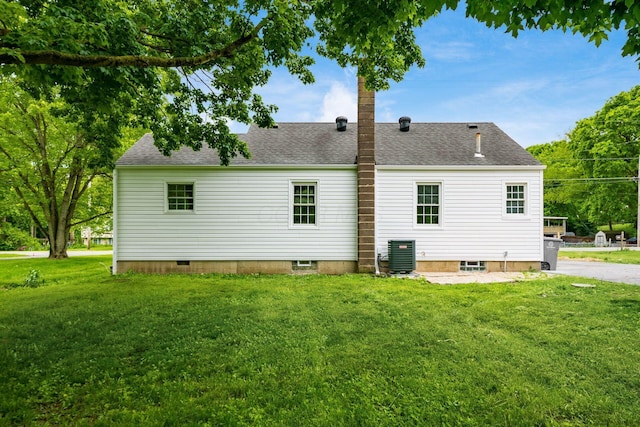 3232 Williams Rd, Columbus, OH 43207 - rear view of property with a lawn, a shingled roof, and central AC