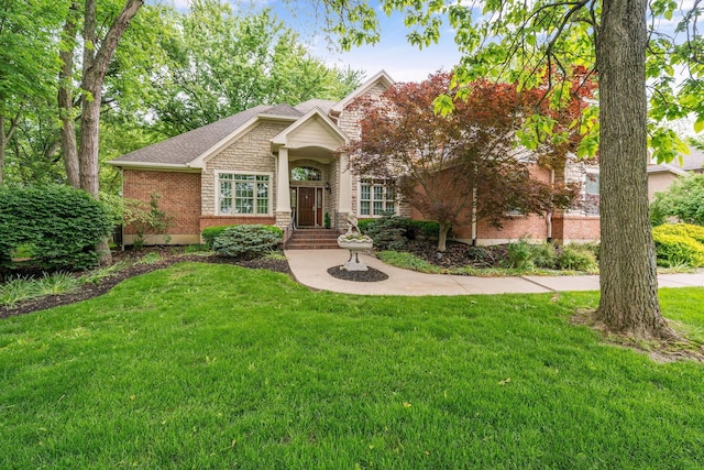 7607 Stone Ridge Dr, Springboro, OH 45066 - view of front of house with a front lawn, stone siding, brick siding, and a shingled roof