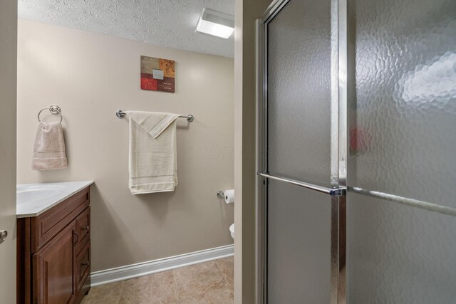 7607 Stone Ridge Dr, Springboro, OH 45066 - bathroom with vanity, baseboards, toilet, a shower with door, and tile patterned floors