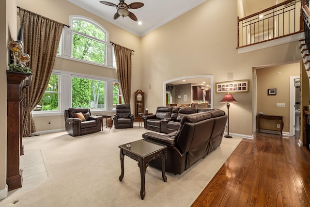 7607 Stone Ridge Dr, Springboro, OH 45066 - living room with baseboards, ceiling fan, crown molding, a towering ceiling, and plenty of natural light