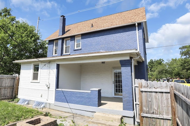 399 E Woodrow Ave, Columbus, OH 43207 - rear view of house featuring brick siding and a chimney