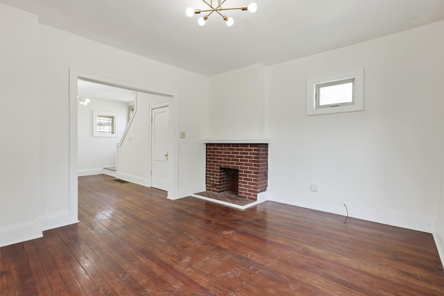 399 E Woodrow Ave, Columbus, OH 43207 - unfurnished living room featuring a chandelier, hardwood / wood-style floors, and a fireplace
