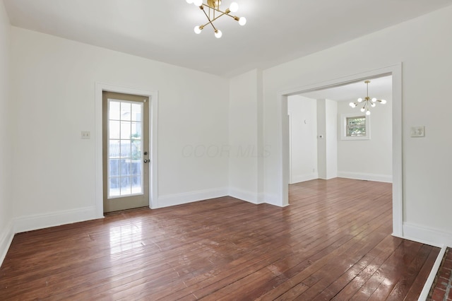 399 E Woodrow Ave, Columbus, OH 43207 - unfurnished room featuring a chandelier and dark wood-style flooring
