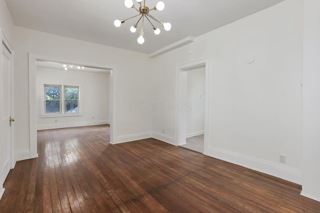 399 E Woodrow Ave, Columbus, OH 43207 - spare room with a chandelier and dark wood-style flooring