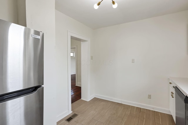 399 E Woodrow Ave, Columbus, OH 43207 - kitchen with appliances with stainless steel finishes, light countertops, and light wood-style floors