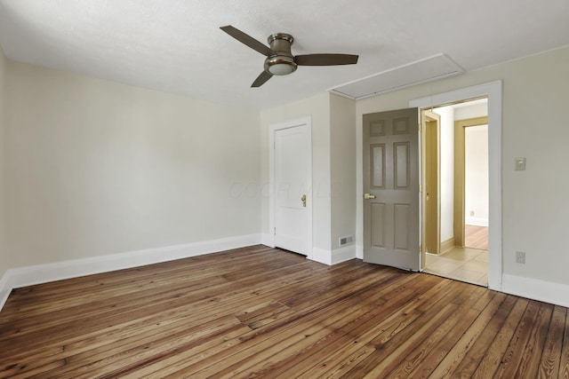 399 E Woodrow Ave, Columbus, OH 43207 - unfurnished bedroom featuring attic access, hardwood / wood-style floors, and a ceiling fan