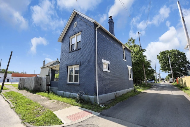 399 E Woodrow Ave, Columbus, OH 43207 - view of home's exterior featuring a chimney and brick siding
