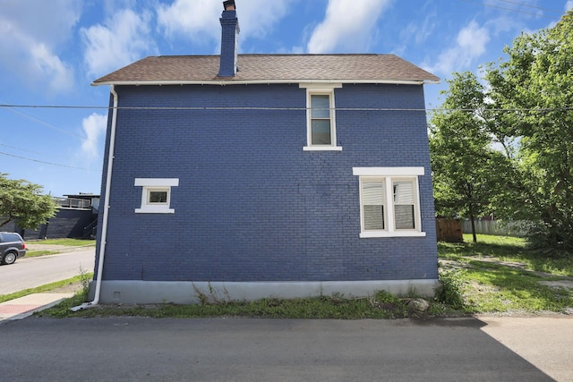 399 E Woodrow Ave, Columbus, OH 43207 - view of side of home featuring brick siding and a chimney