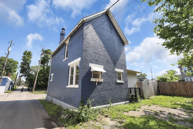 399 E Woodrow Ave, Columbus, OH 43207 - view of home's exterior featuring brick siding and a chimney