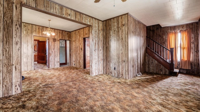 8045 Old Town Rd, Roseville, OH 43777 - unfurnished room featuring carpet flooring, stairs, a chandelier, ceiling fan, and wooden walls