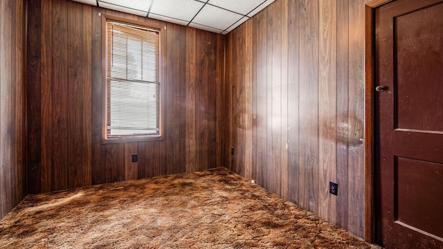8045 Old Town Rd, Roseville, OH 43777 - unfurnished room with wooden walls, a drop ceiling, and carpet floors
