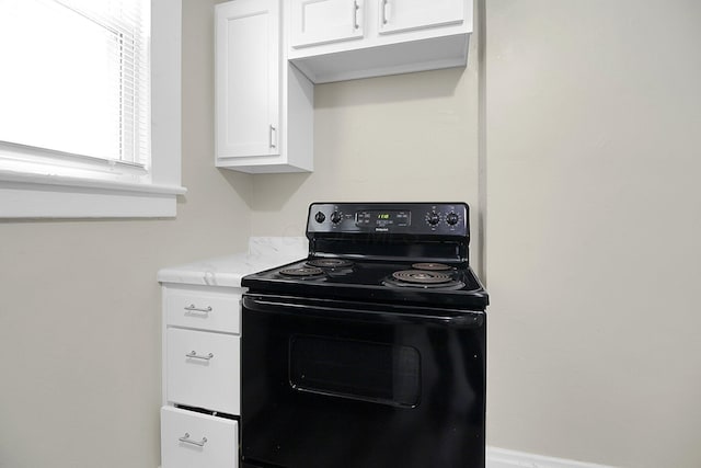 162 Columbian Ave Unit 164, Columbus, OH 43223 - kitchen featuring black range with electric stovetop, white cabinets, and light stone countertops