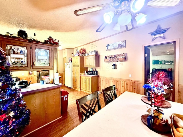 37855 Maysville Greendale Rd, Logan, OH 43138 - dining area with a wainscoted wall, light wood-style floors, a textured ceiling, ceiling fan, and wood walls