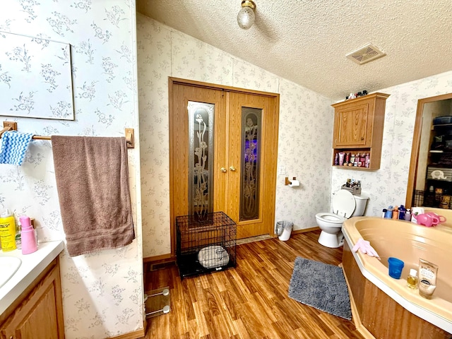 37855 Maysville Greendale Rd, Logan, OH 43138 - full bathroom with wood finished floors, vanity, lofted ceiling, a bath, and toilet