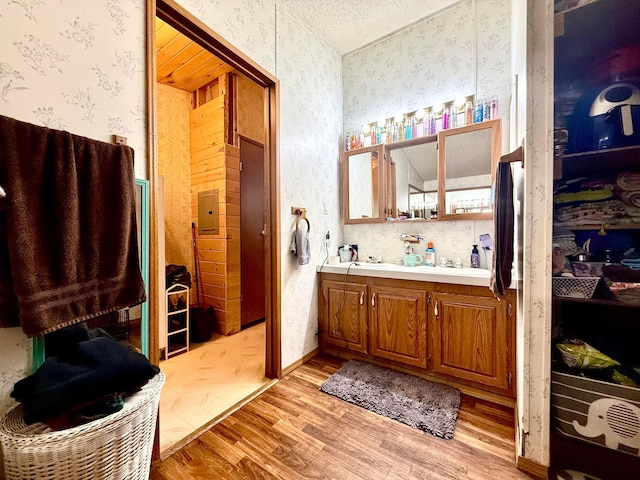 37855 Maysville Greendale Rd, Logan, OH 43138 - full bath with wallpapered walls, wood finished floors, and double vanity