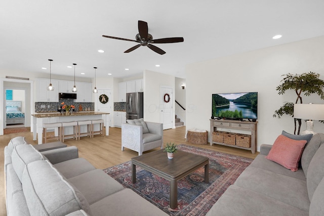 2618 Triple Crown Xing, Powell, OH 43065 - living area featuring ceiling fan, stairway, recessed lighting, and light wood-style floors