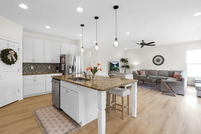 2618 Triple Crown Xing, Powell, OH 43065 - kitchen featuring stainless steel appliances, a sink, ceiling fan, light wood-type flooring, and recessed lighting