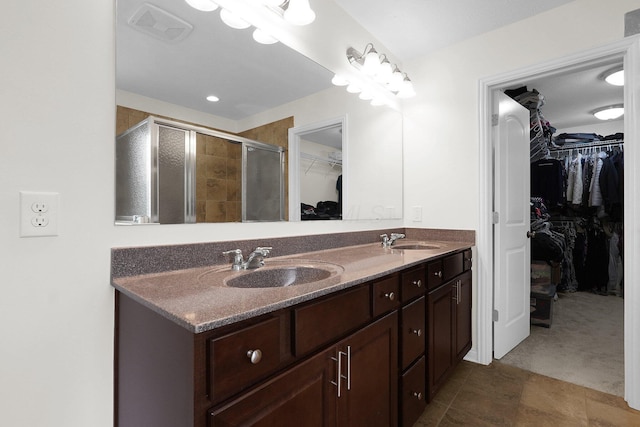 2618 Triple Crown Xing, Powell, OH 43065 - bathroom featuring a walk in closet, double vanity, a stall shower, and tile patterned floors