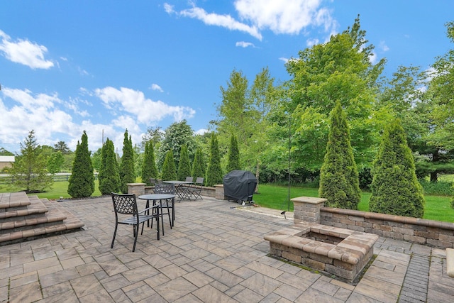 2618 Triple Crown Xing, Powell, OH 43065 - view of patio / terrace featuring a grill, outdoor dining space, and a fire pit