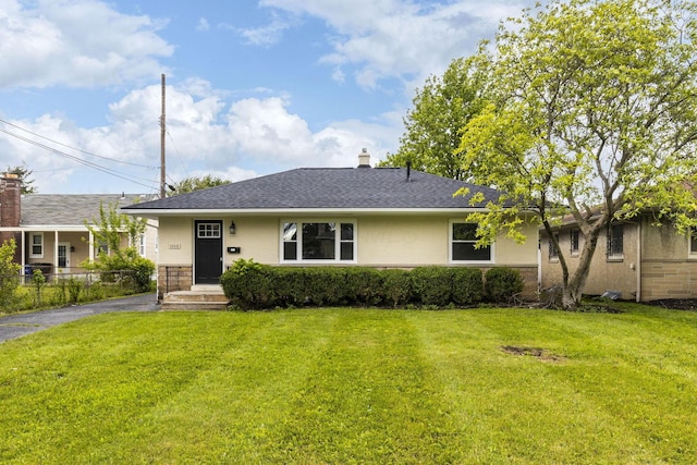 1068 E Markison Ave, Columbus, OH 43207 - view of front of home featuring a front lawn, stucco siding, a chimney, and a shingled roof