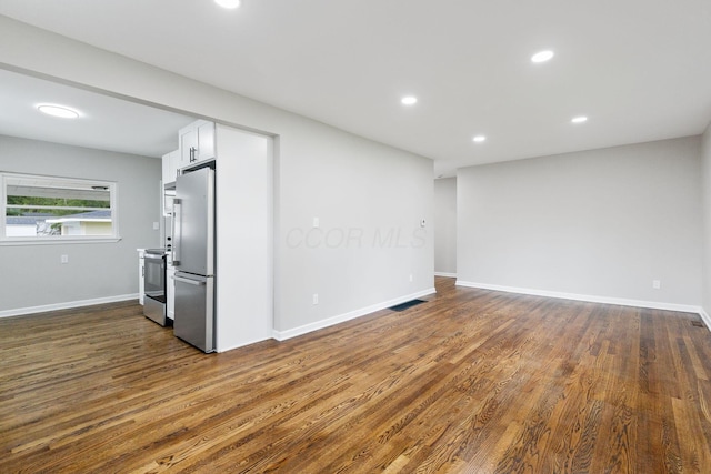 1068 E Markison Ave, Columbus, OH 43207 - empty room with dark wood-type flooring, recessed lighting, and baseboards