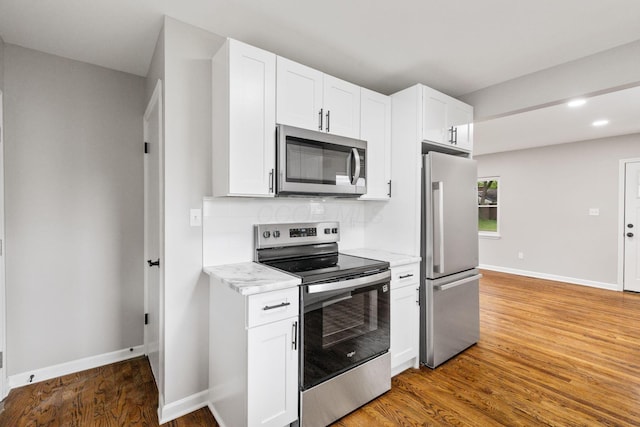 1068 E Markison Ave, Columbus, OH 43207 - kitchen featuring appliances with stainless steel finishes, light wood finished floors, white cabinetry, and recessed lighting