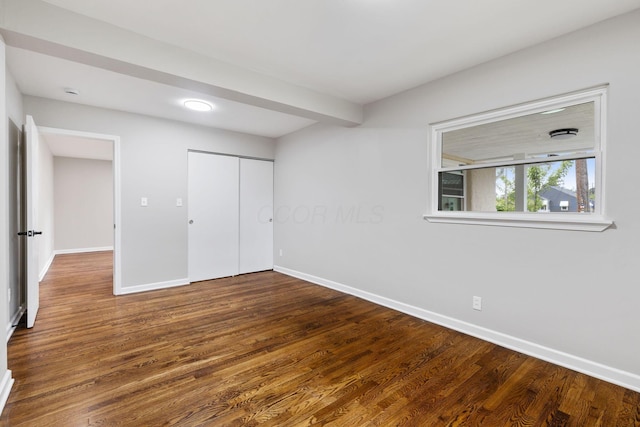 1068 E Markison Ave, Columbus, OH 43207 - unfurnished bedroom with wood finished floors, baseboards, and a closet