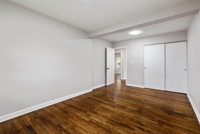 1068 E Markison Ave, Columbus, OH 43207 - unfurnished bedroom with dark wood-type flooring, baseboards, and a closet