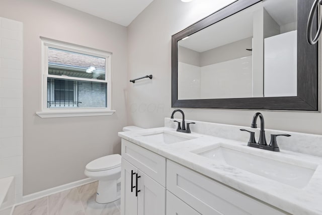 1068 E Markison Ave, Columbus, OH 43207 - full bath featuring double vanity, baseboards, toilet, and marble finish flooring