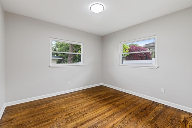 1068 E Markison Ave, Columbus, OH 43207 - spare room with baseboards, healthy amount of natural light, and dark wood-style floors