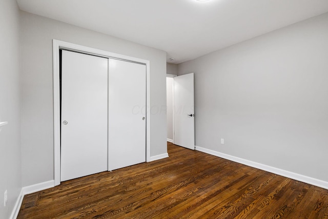 1068 E Markison Ave, Columbus, OH 43207 - unfurnished bedroom featuring wood finished floors, a closet, and baseboards