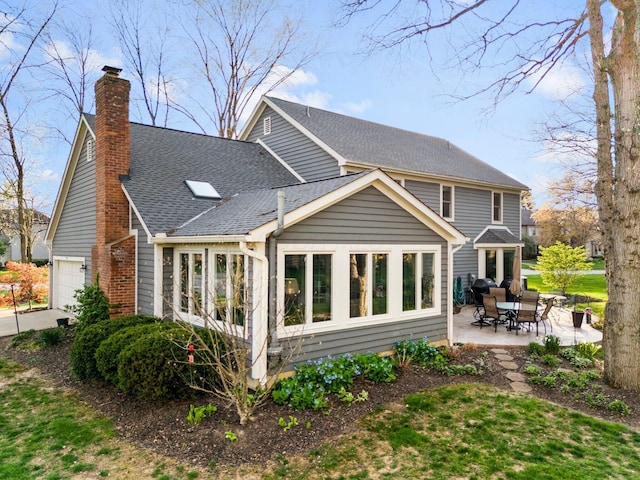 9440 Culross Ct, Dublin, OH 43017 - back of property with a patio, a chimney, and a shingled roof