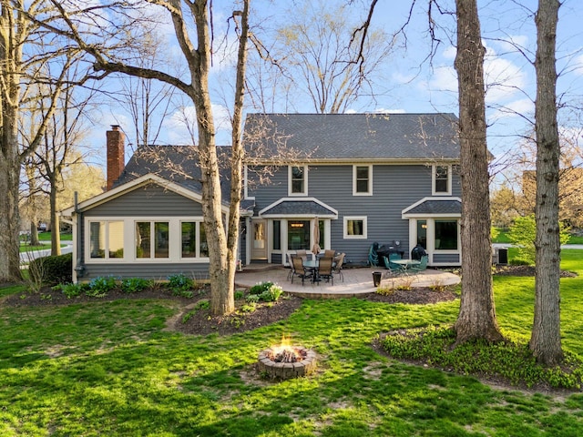 9440 Culross Ct, Dublin, OH 43017 - rear view of property with an outdoor fire pit, a patio area, a yard, a chimney, and roof with shingles