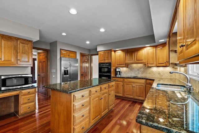 9440 Culross Ct, Dublin, OH 43017 - kitchen with black appliances, a sink, dark wood-type flooring, a kitchen island, and dark stone counters