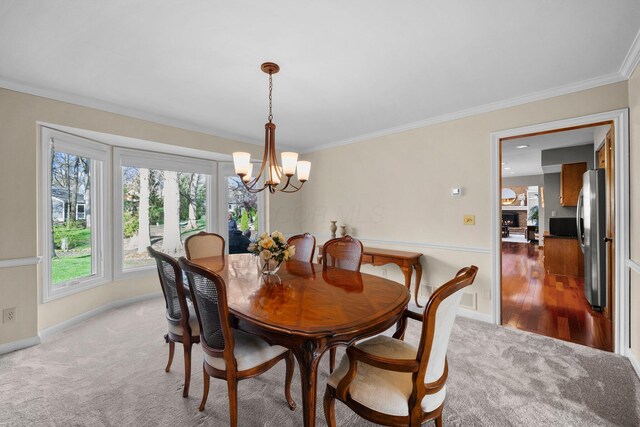 9440 Culross Ct, Dublin, OH 43017 - dining area featuring a chandelier, carpet floors, crown molding, and baseboards
