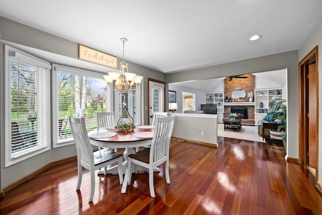9440 Culross Ct, Dublin, OH 43017 - dining room featuring a chandelier, baseboards, dark wood finished floors, a brick fireplace, and recessed lighting