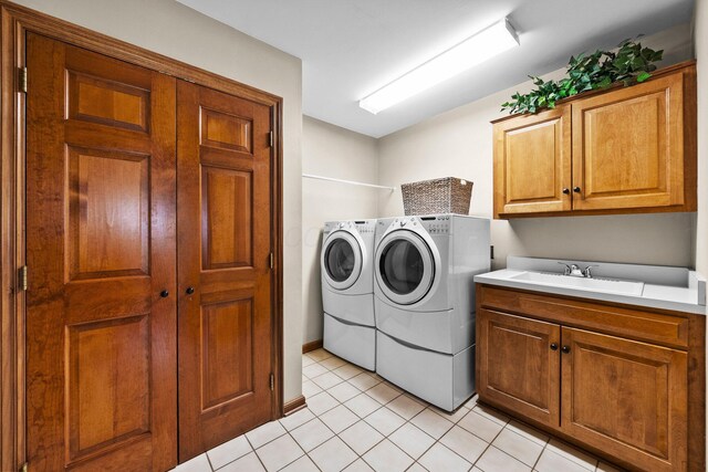 9440 Culross Ct, Dublin, OH 43017 - washroom featuring washer and dryer, cabinet space, and light tile patterned floors