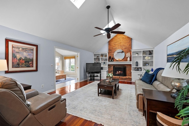 9440 Culross Ct, Dublin, OH 43017 - living room with ceiling fan, wood finished floors, lofted ceiling, a skylight, and built in shelves
