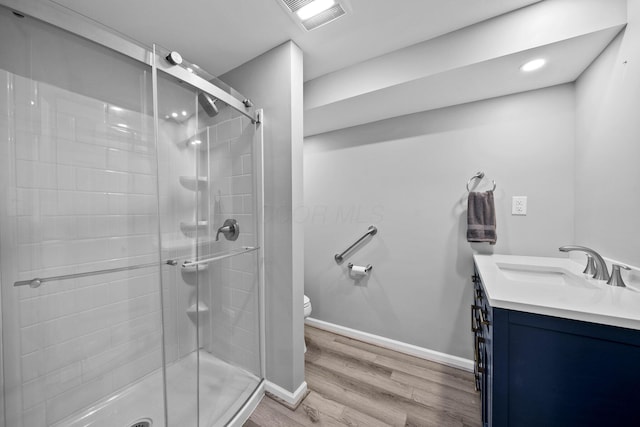 9440 Culross Ct, Dublin, OH 43017 - bathroom with vanity, toilet, wood finished floors, a stall shower, and baseboards