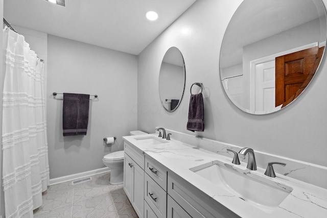 9440 Culross Ct, Dublin, OH 43017 - full bath featuring double vanity, toilet, recessed lighting, and baseboards