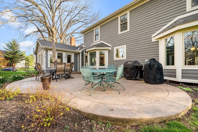 9440 Culross Ct, Dublin, OH 43017 - back of property featuring a patio, outdoor dining space, and a chimney