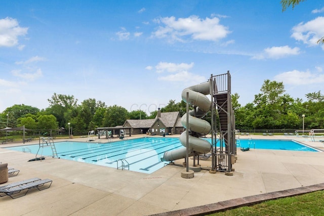 9440 Culross Ct, Dublin, OH 43017 - community pool with a water slide, a patio area, and view of wooded area